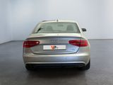 the rear end of a silver audi parked in a white room