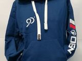 un gros plan sur une personne portant un sweat à capuche bleu et un pantalon bleu