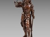 a bronze statue of a man with a trumpet on a pedestal
