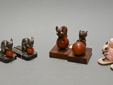 three figurines of animals sitting on top of a table