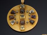 two pieces of jewelry are displayed on a black surface