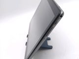a tablet that is sitting on a stand on a table