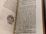 an open book on a table with a black and white image of a bird on it