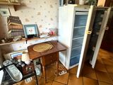 une petite cuisine équipée d'un réfrigérateur et d'une table