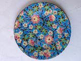 a blue plate with a floral design on it