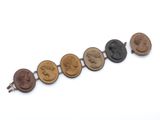 a close up of a row of coins with faces on them