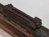 a close up of a rifle with a wooden handle