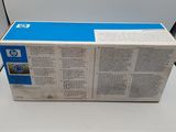 a close up of a box of blue ink on a white surface