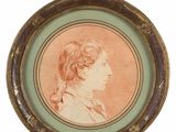 an oval portrait of a young boy in profile in a green frame