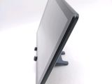 a tablet computer sitting on a stand on a white surface