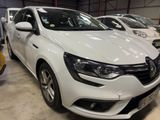 the front end of a white car parked in a garage