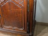 a wooden cabinet with a marble top on a tiled floor