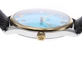 a close up of a watch with a blue dial