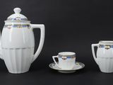 a white tea set with a cup and saucer