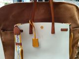 brown and white tote bag with a yellow handle