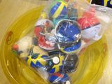 a yellow plate filled with assorted toys on a table