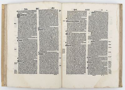 an open book with a page of text on it on a white surface
