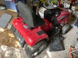a red lawn mower parked in a garage