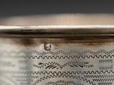 a close up of a silver cup with designs on it