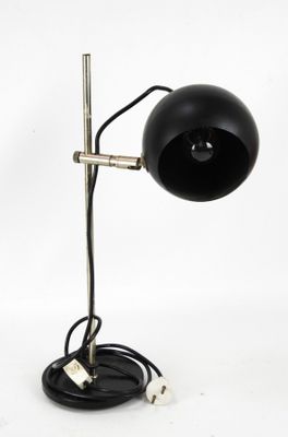 an image of a black lamp on a metal stand on a white background