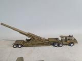 a toy army truck with a gun on the back of it