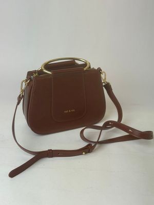 a brown purse with a gold handle on a white background