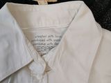 a white shirt and a black shirt sitting on a table