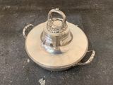 an antique silver plate with a crown on top of it