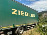 a large green truck that is parked on the side of the road