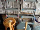 many chairs and tables in a store with boxes of boxes behind them
