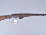 an old rifle with a wooden barrel and a tag on it