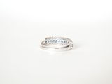 a close up of a diamond ring on a white surface