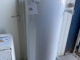 a white water heater sitting next to a white refrigerator