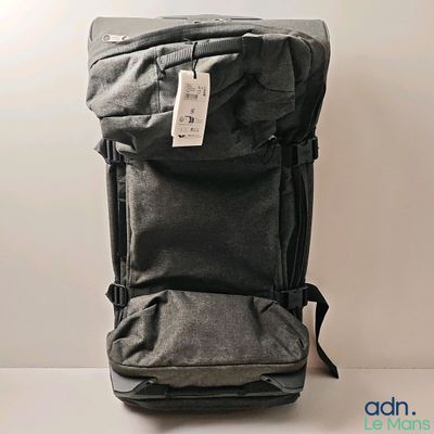 a black backpack with a tag on it sitting on a table