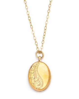 a gold locke necklace with a paisley design on it