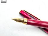 two pens that are laying next to each other on a table