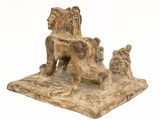 statue of a lion and a dog on a stone base