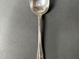 silver spoon on a table with a black background