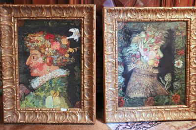two framed pictures of a woman and a bird on a table