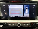 the view of a car ' s rear view camera from the driver ' s seat