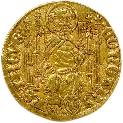 gros plan d'une pièce d'or sur une surface blanche