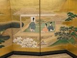 a room divider with a painting of a man and a woman sitting on a bench