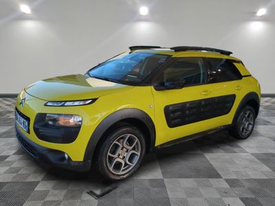 a yellow car parked in a room with a checkered floor