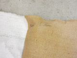 a piece of fabric on the floor next to a pillow