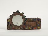 a small mirror sitting on top of a piece of wood