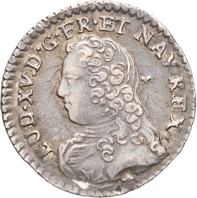 Gros plan sur une pièce d'argent portant une tête d'homme