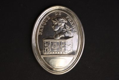 a picture of a silver coin with a picture of a woman on it