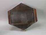 a small mirror that is on a stand on a table