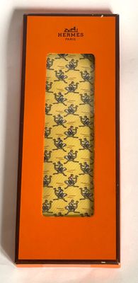 an orange box with a tie in it sitting on a white surface