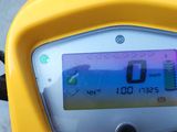 a yellow motorcycle with a digital display on the back of it